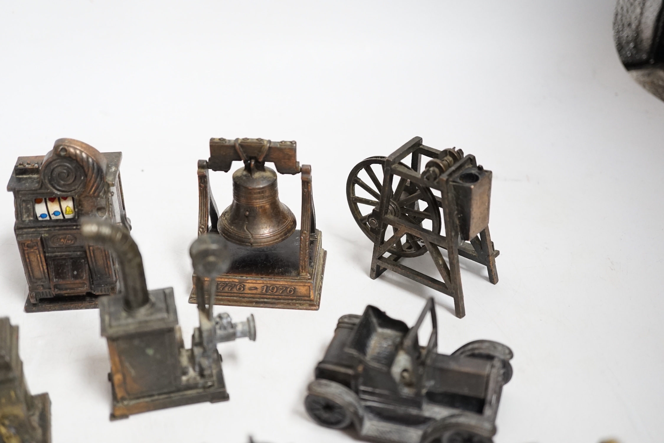 A collection of novelty metal pencil sharpeners and a pair of late Georgian silver plated candlesticks, 20cm